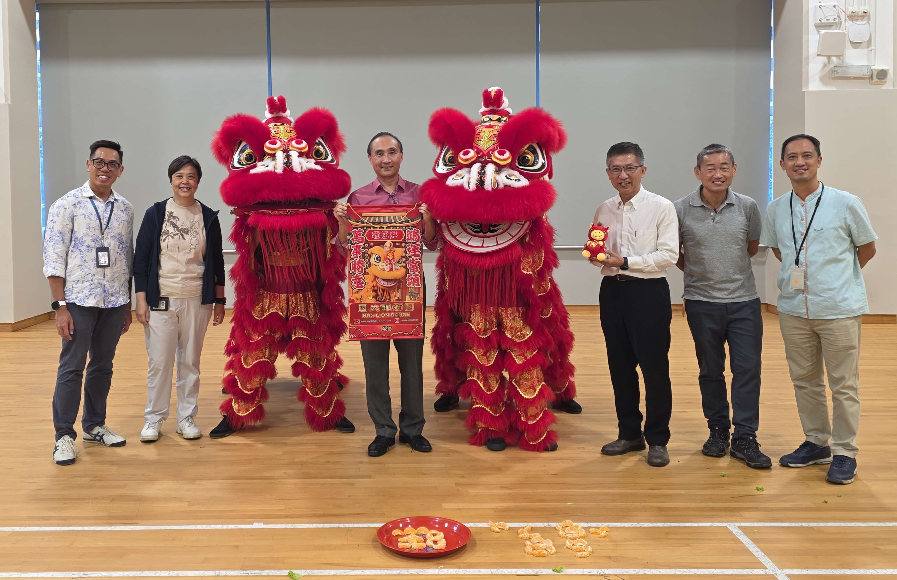 Image of management with lion dance troupe